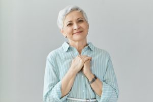 Portrait of generous kind mature senior female in stylish shirt