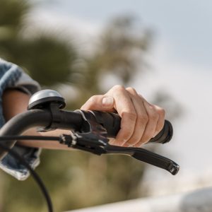 woman-holding-her-hand-handlebar-grip