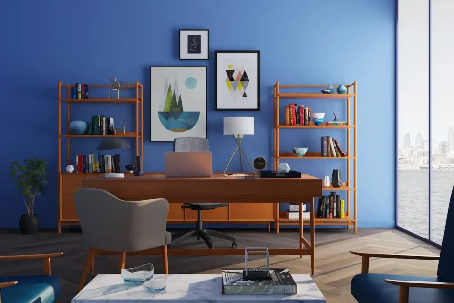 Sala de escritório moderna com decoração em tons de azul, móveis de madeira e obras de arte na parede, refletindo tendências de decoração para 2025.